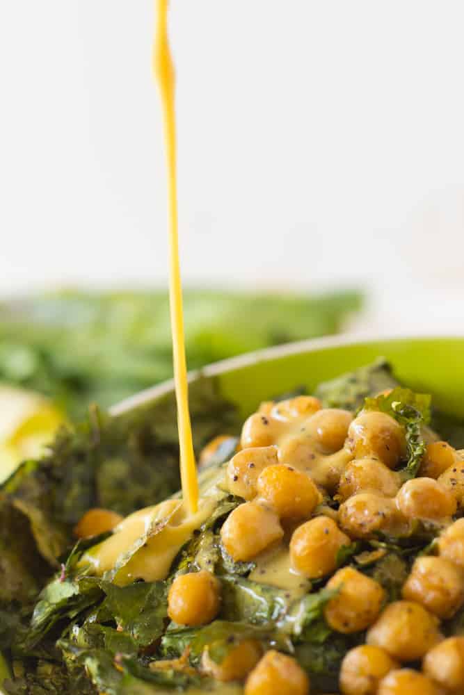 Pouring dressing onto chickpea salad. 