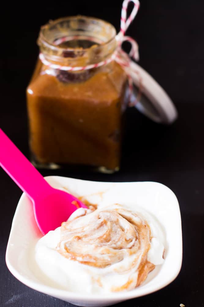 Date syrup being mixed into yogurt.