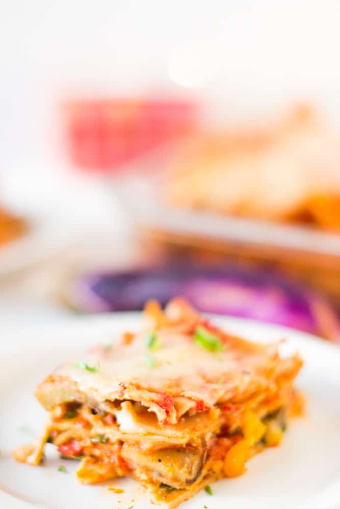 Slice of vegetable lasagna on a white plate.