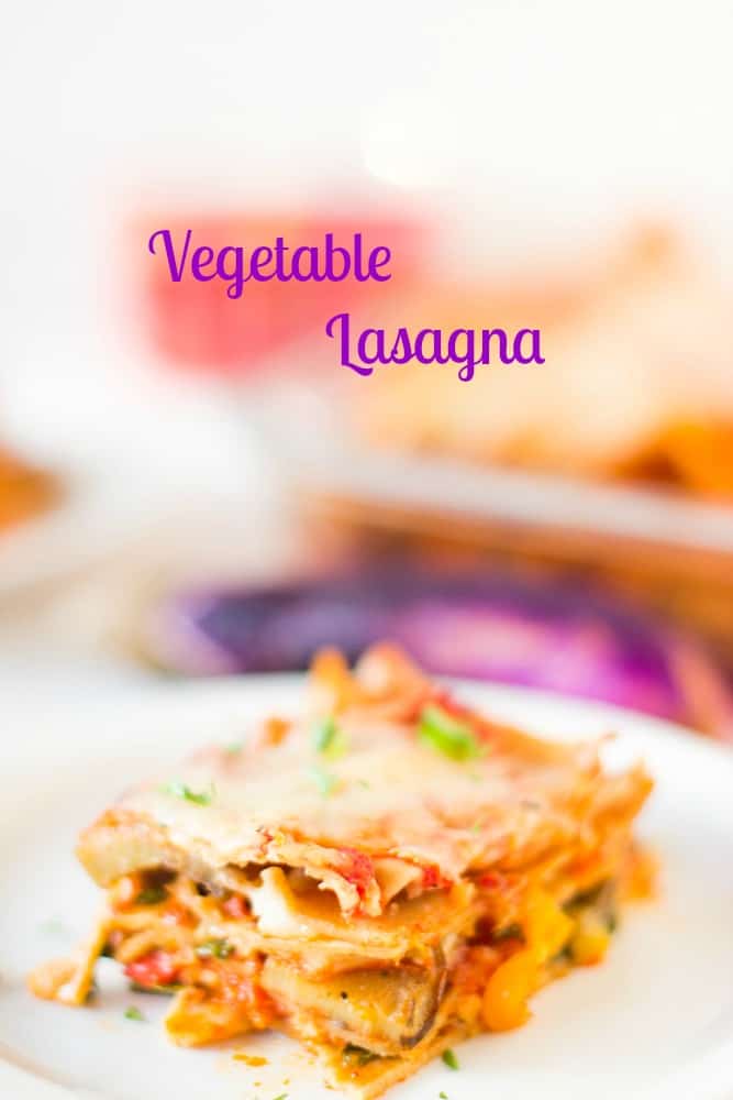 A slice of vegetable lasagna on a white plate. 
