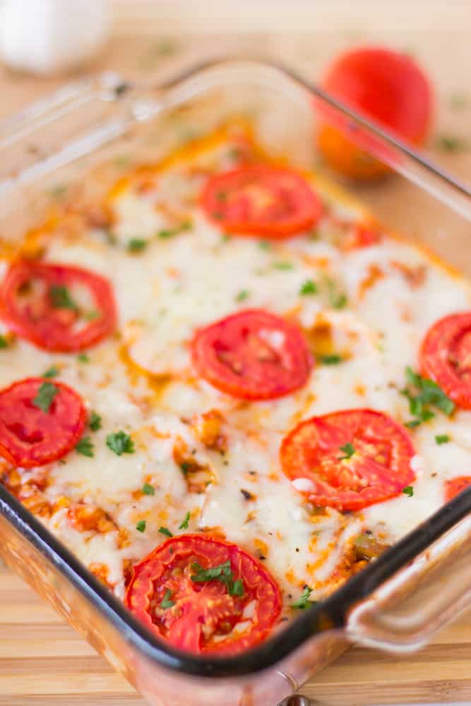 Overhead shot of cauliflower pizza casserole in a glass baking dish.