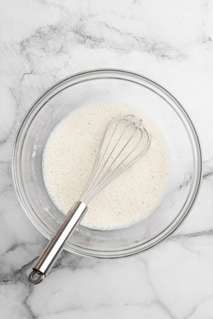 These Cauliflower Bites are crispy, crunchy and full of big flavour thanks to an irresistible sweet sriracha sauce. A total crowd pleaser! Overhead view of batter mixture in bowl with whisk