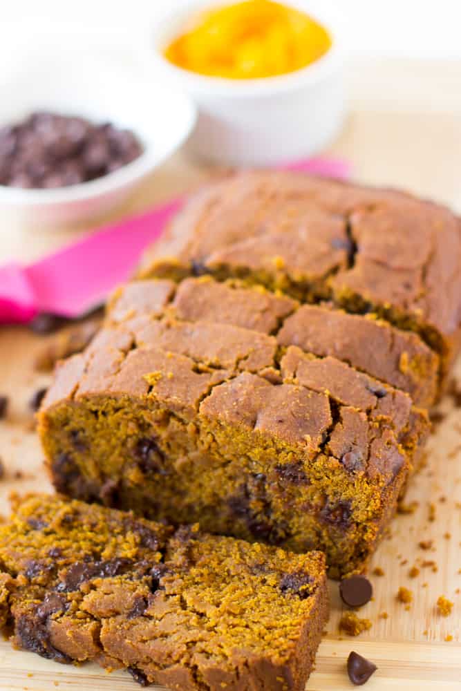 Sliced vegan pumpkin chocolate chip bread on a wooden board. 