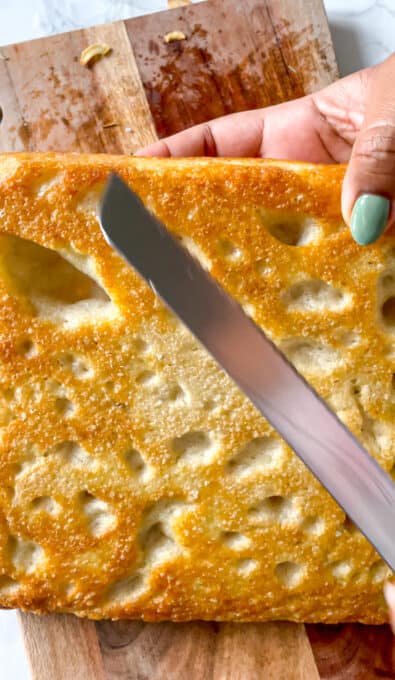 knife to the back of focaccia bread to show crispiness