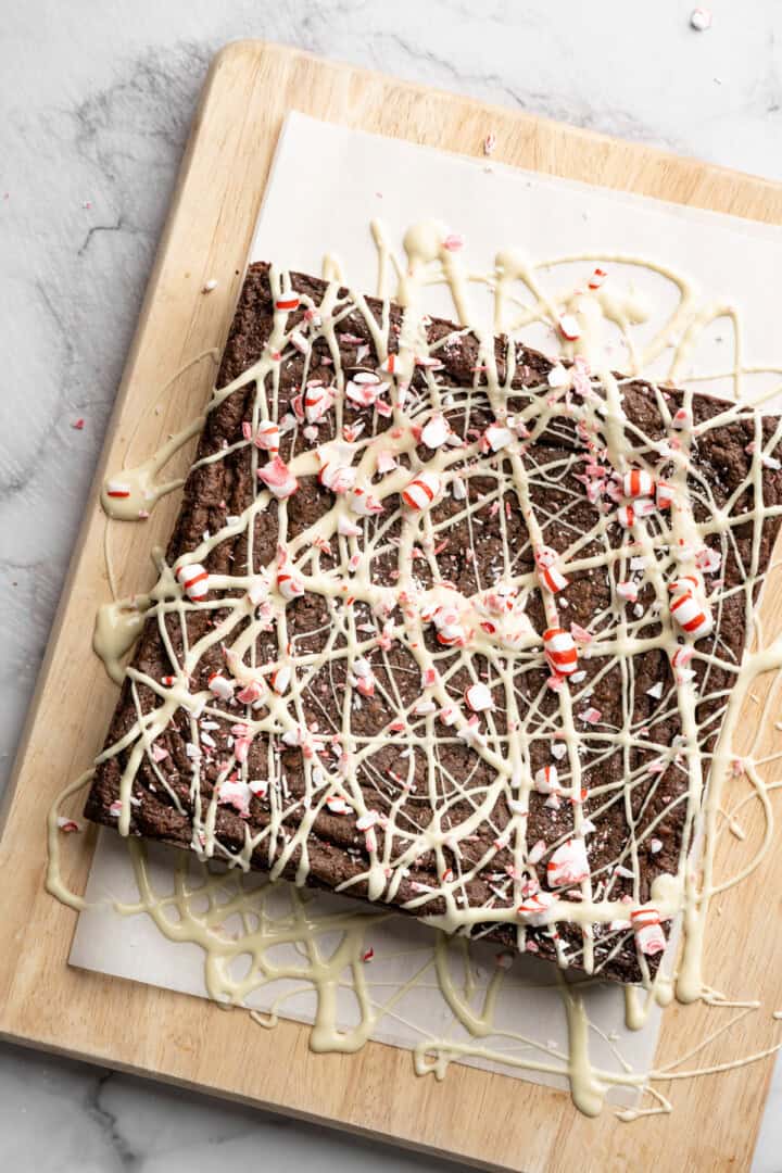 Peppermint brownies with white chocolate drizzle and candy canes.