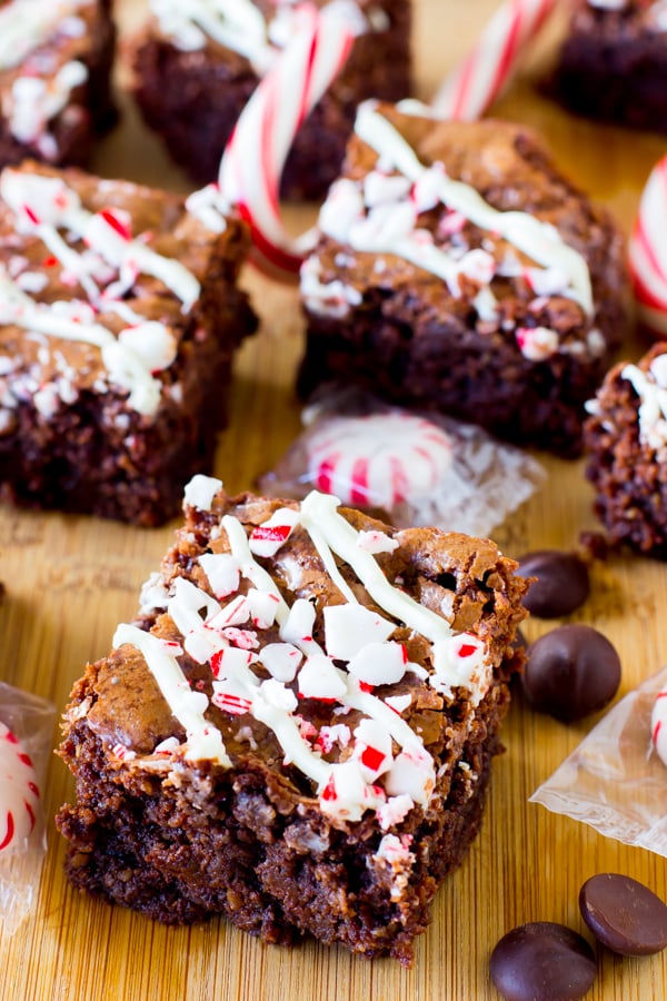 A batch of peppermint chocolate brownies on a wooden table. 