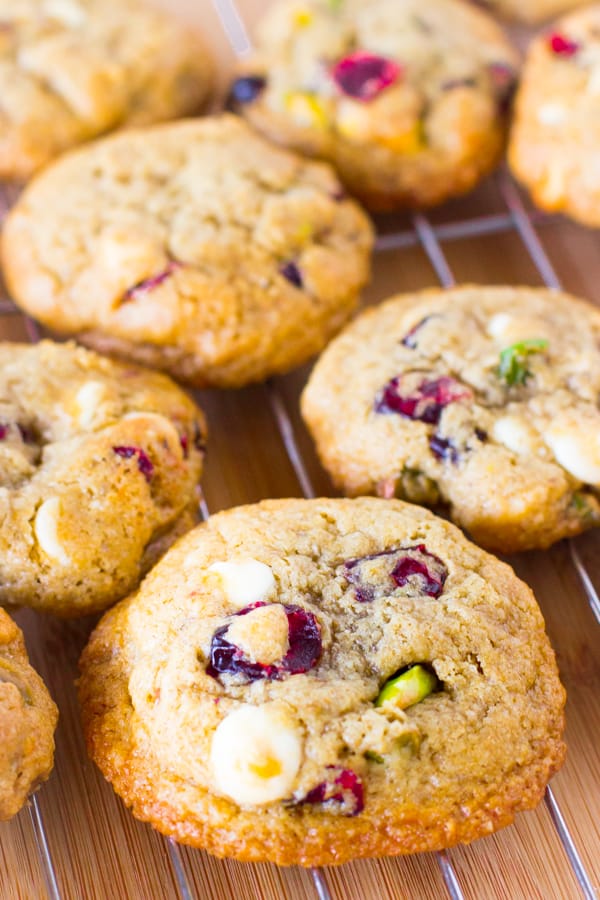 Flourless white chocolate cranberry pistachio cookies on a wire rack.