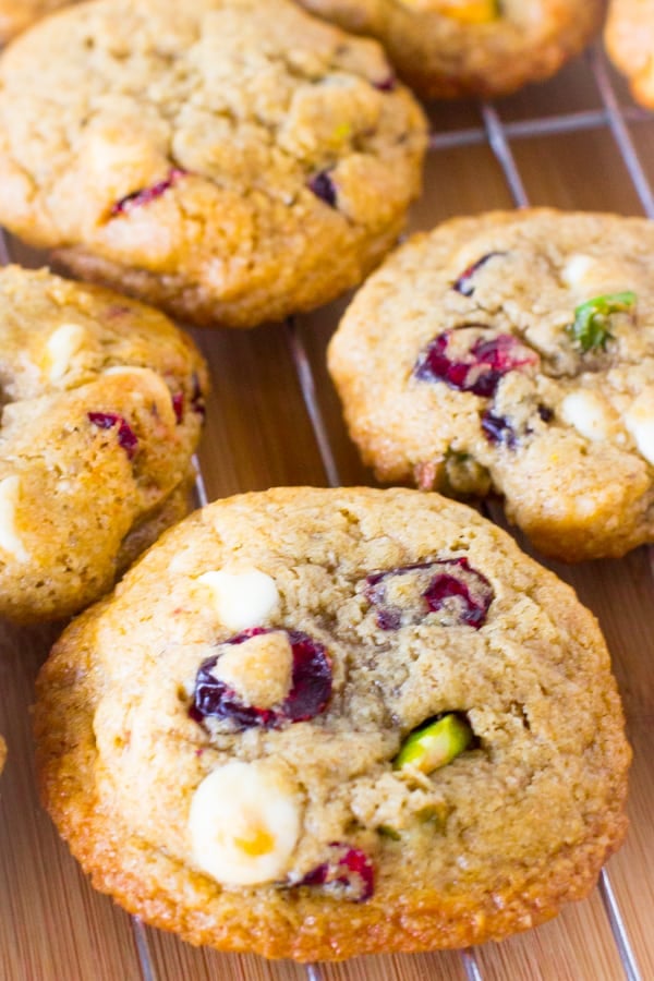 Overhead shot of white chocolate cranberry pistachio cookies on a wire rack.