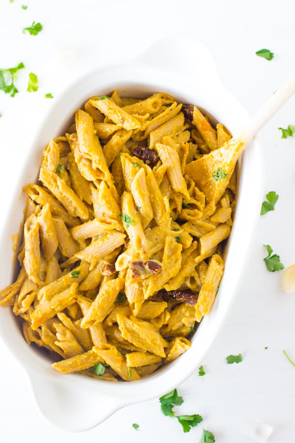 Alfredo penne pasta in a white baking dish.