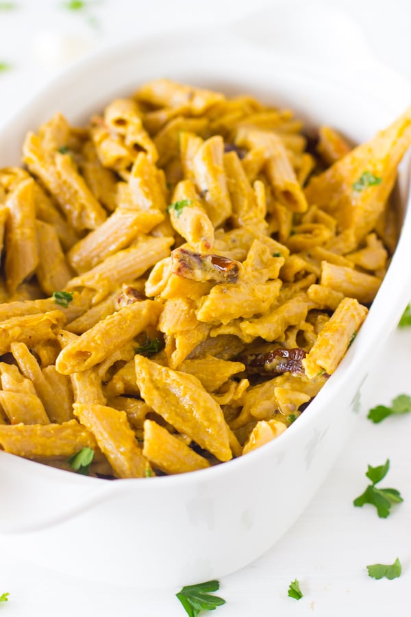 Alfredo penne pasta in a white bowl. 