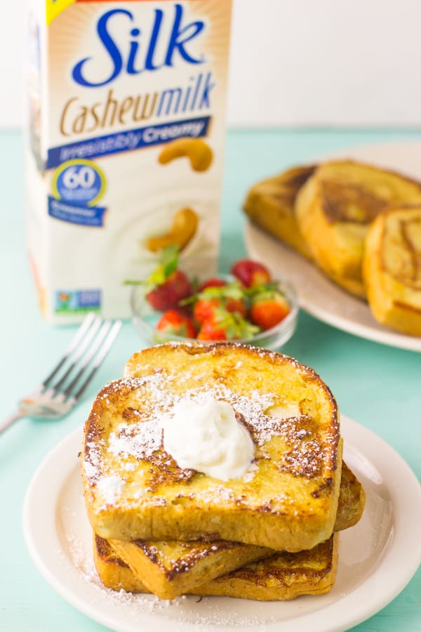 A pile of eggnog french toast on a white plate.