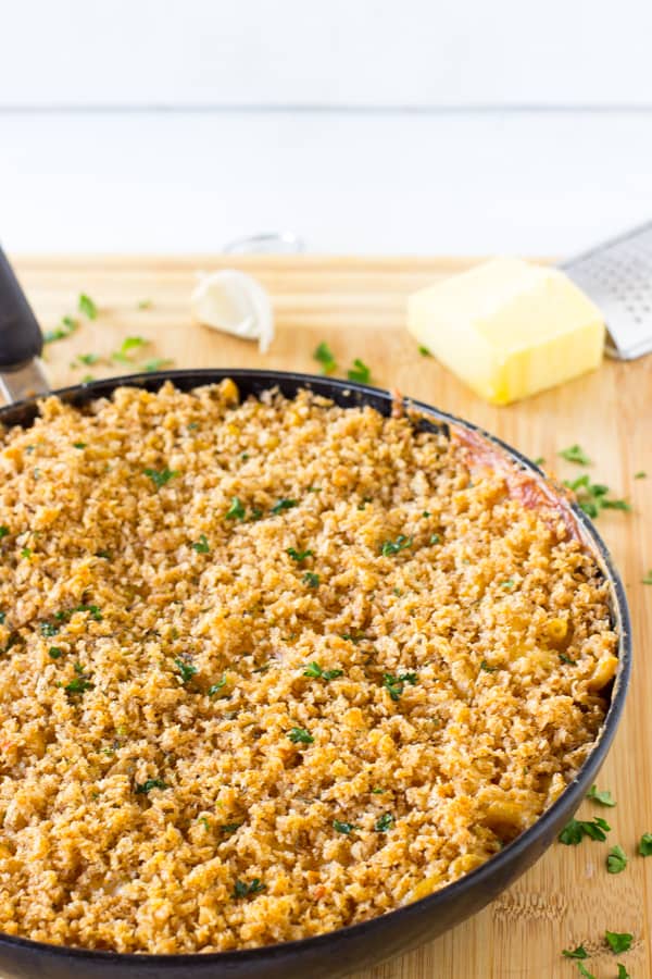 One skillet three cheese baked macaroni and cheese on a table top. 