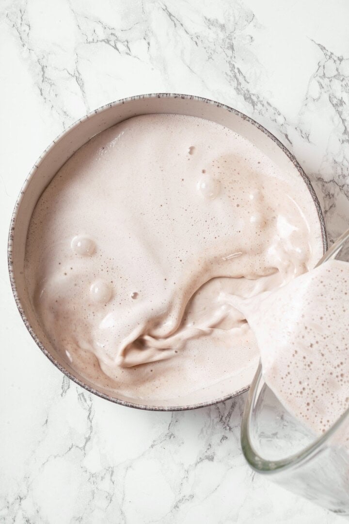 Pouring cashew custard into bowl.