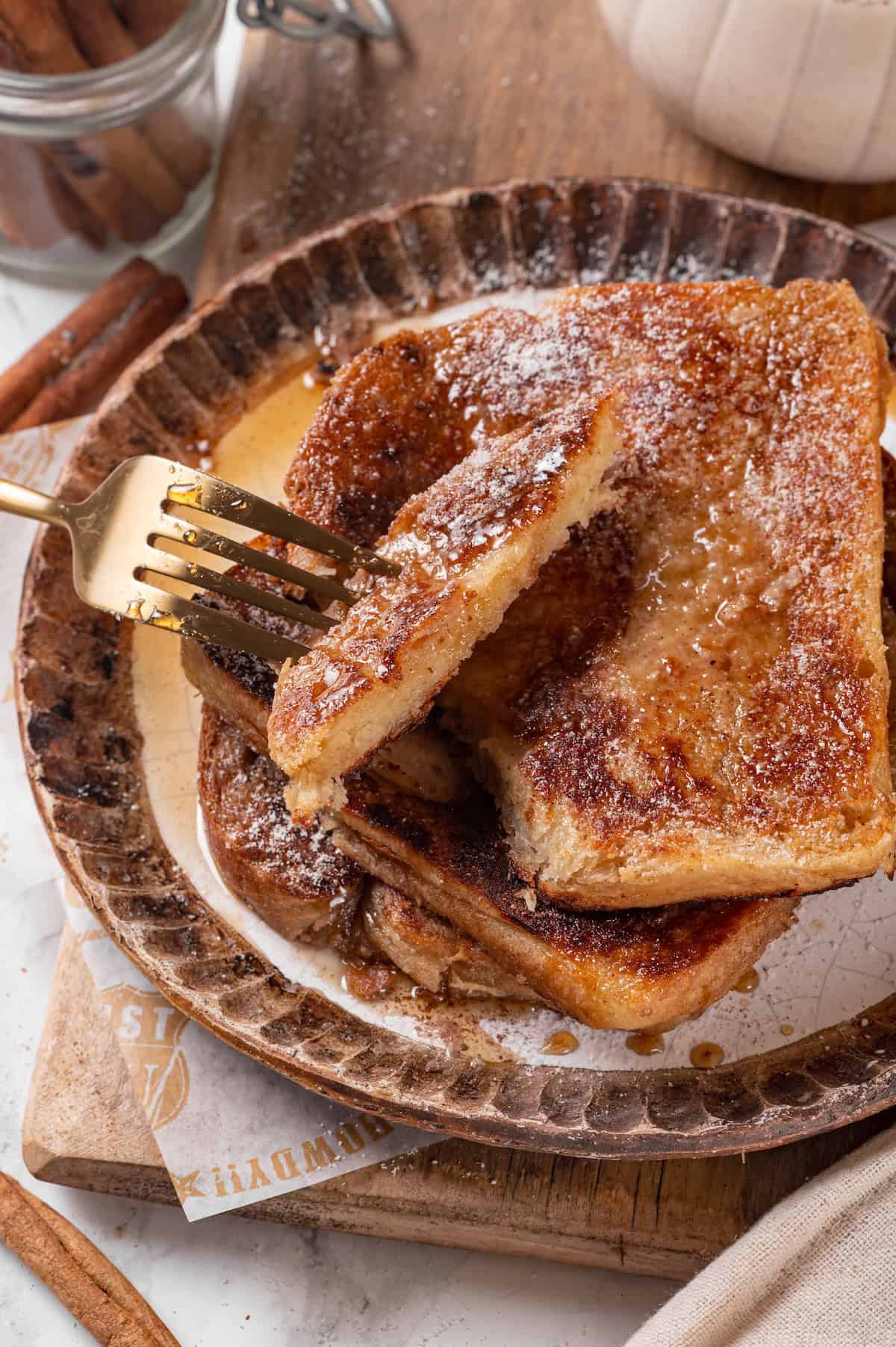 Piece of eggnog French toast on fork.