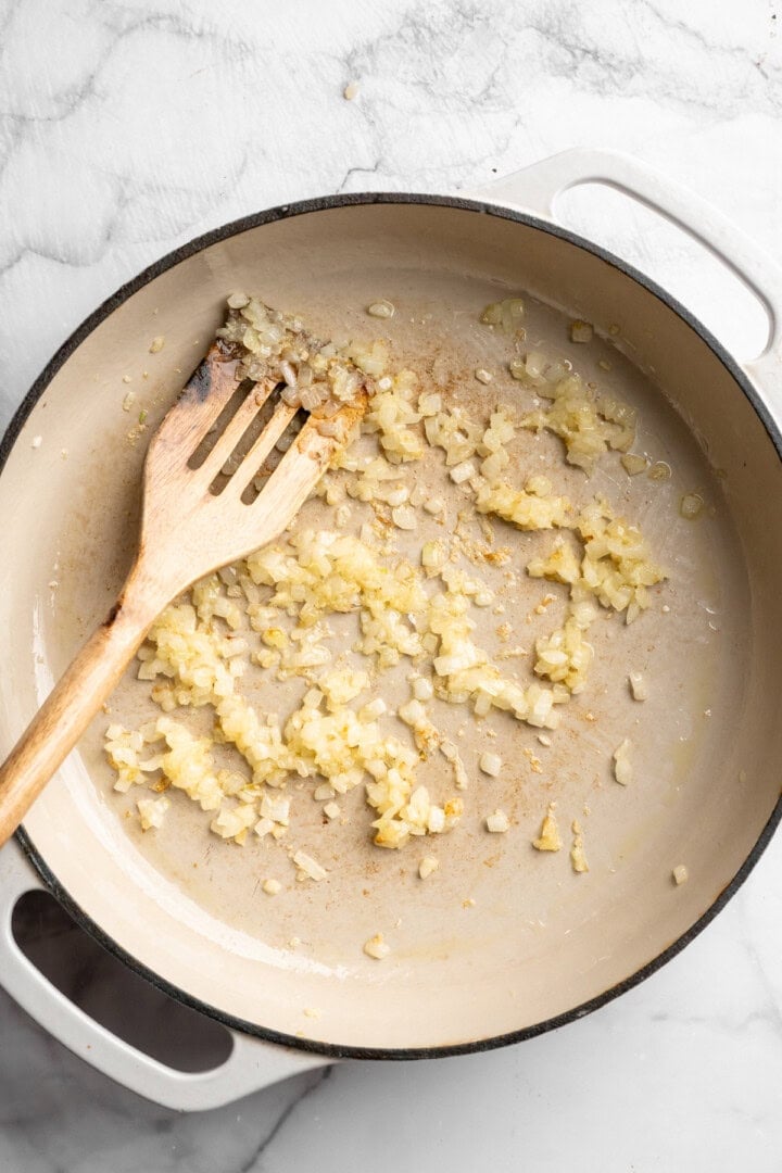 Onion and garlic cooking in skillet.
