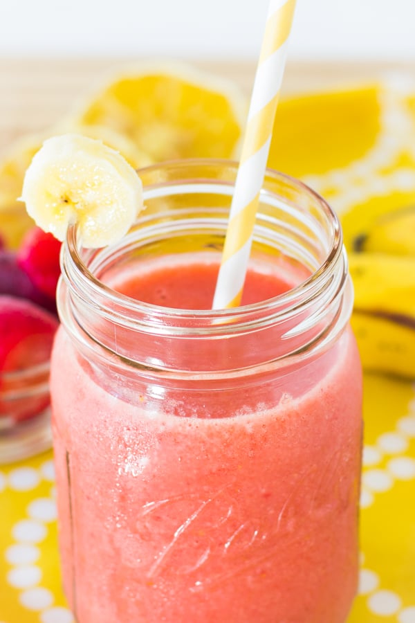  Strawberry Banana Smoothie in a glass jar with a straw.