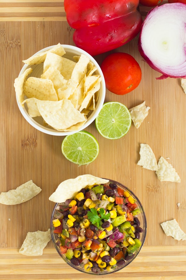 Overhead shot of black bean salsa with a bowl of chips. 