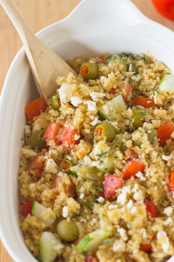 This Mediterranean Quinoa Salad is a quick and easy protein packed quinoa salad loaded with cucumbers, olives, feta cheese and delicious juicy tomatoes! It's all ready in under 30 minutes-2