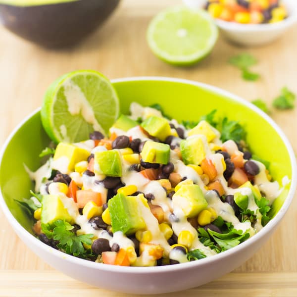 Quinoa and black bean burrito bowl on a wooden table.