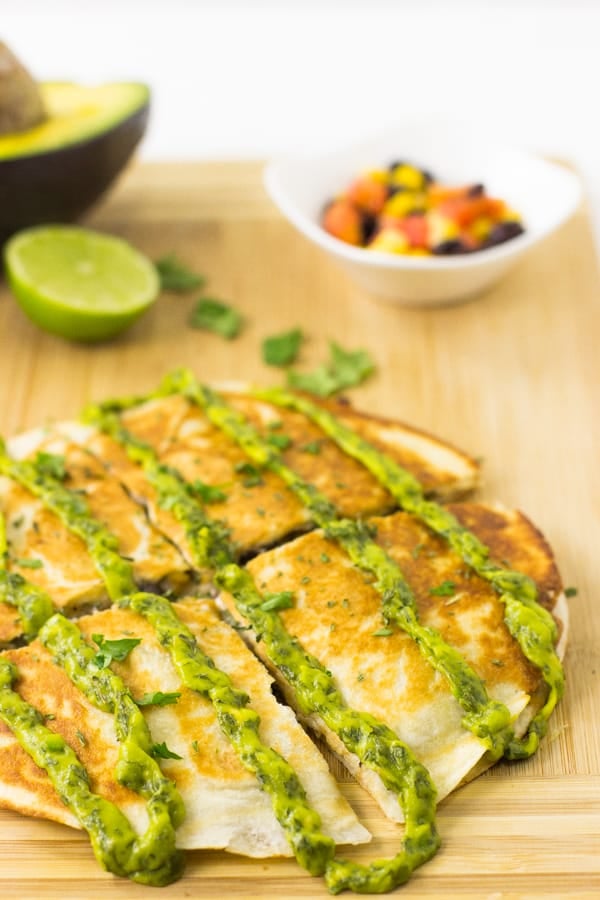Mexican quesadillas sliced on a wooden board. 