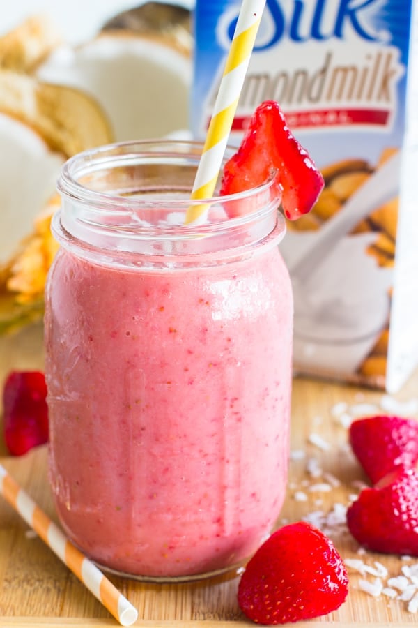 Side shot of strawberry coconut smoothie in a mason jar.