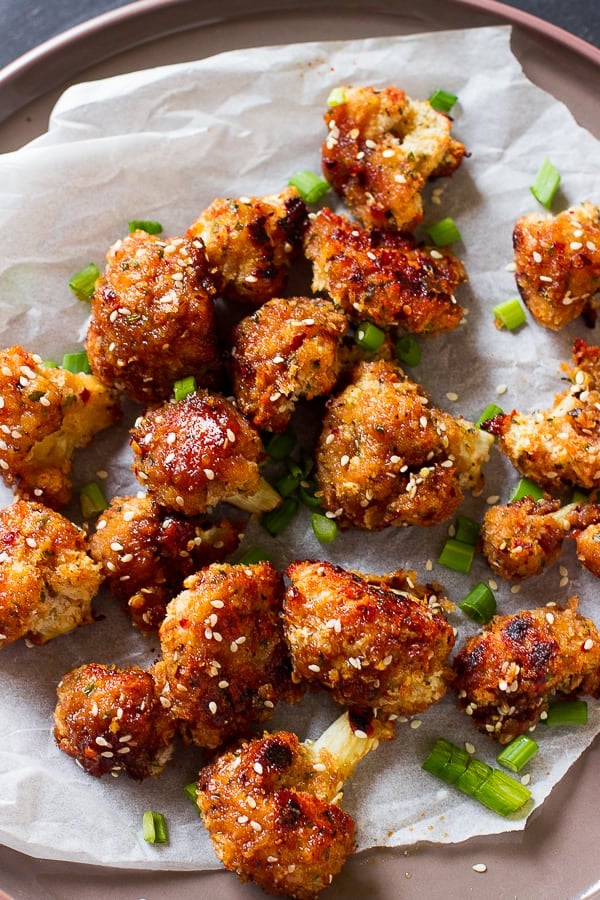 Overhead shot of sticky cauliflower wings on parchment. 