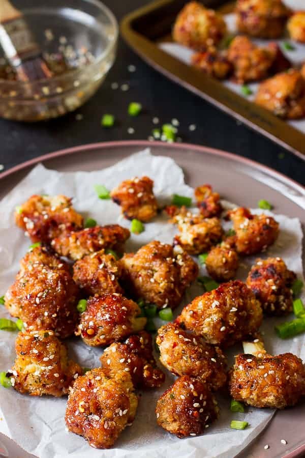 A batch of sticky sesame cauliflower wings on parchment. 