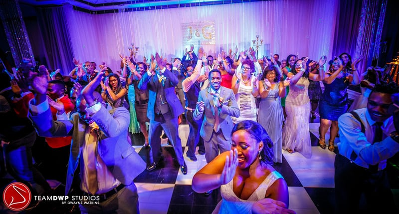 Jessica and wedding guests dancing. 