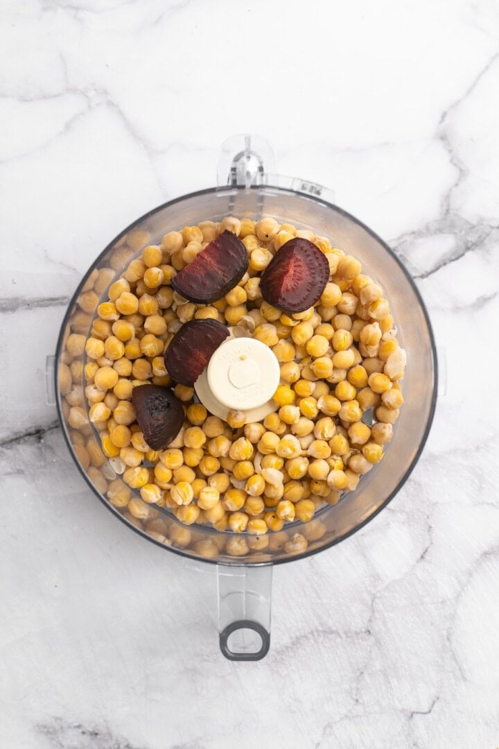Overhead view of beets and chickpeas in food processor