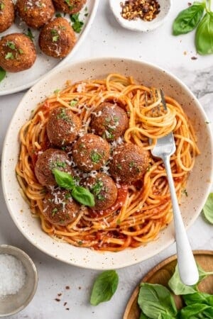 Overhead view of chickpea and beet vegetarian meatballs in bowl of spaghetti