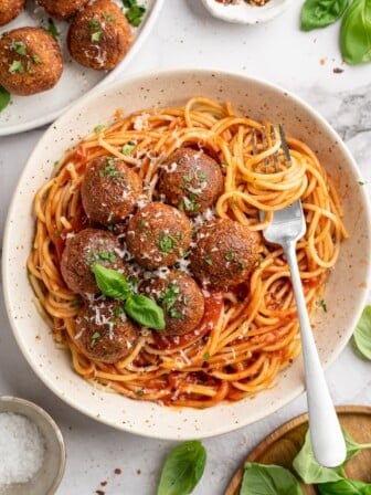 Overhead view of chickpea and beet vegetarian meatballs in bowl of spaghetti