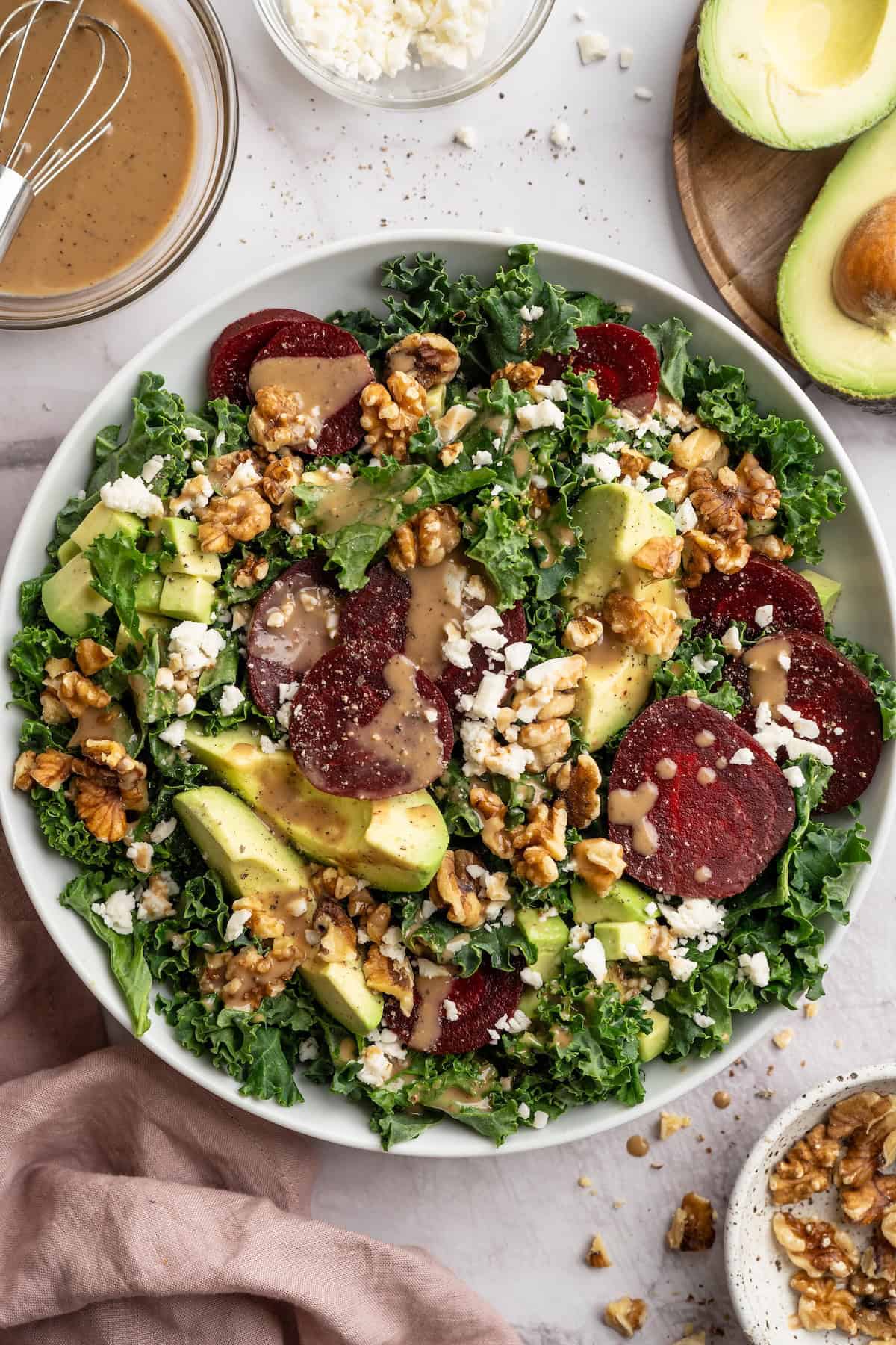 This beet feta salad pairs tender roasted beets and tangy vegan feta, along with a zippy maple mustard vinaigrette. Delicious and easy! Overhead view of vegan beet feta salad in bowl