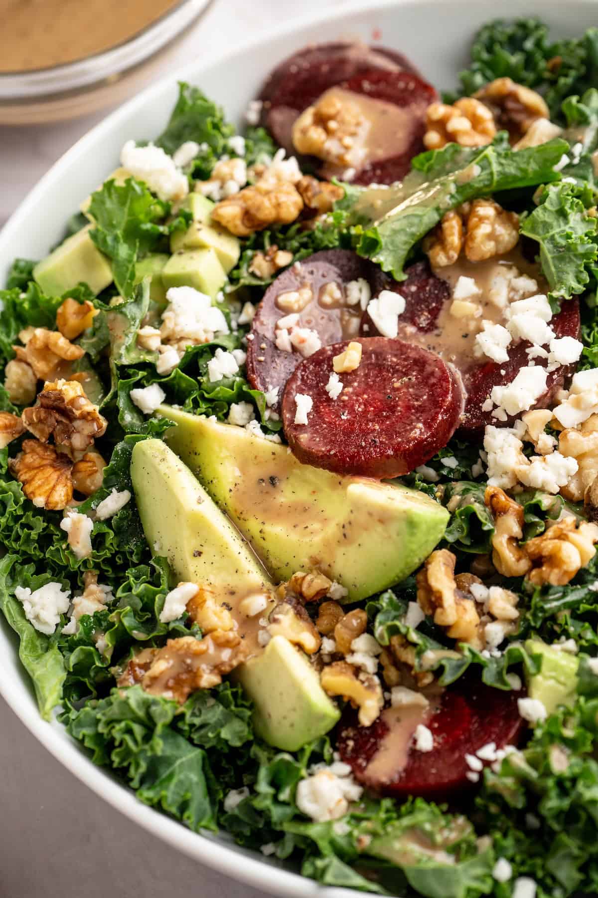 This beet feta salad pairs tender roasted beets and tangy vegan feta, along with a zippy maple mustard vinaigrette. Delicious and easy! Beet feta salad in bowl