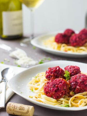 Chickpea and beet vegetarian meatballs with spaghetti on a plate.