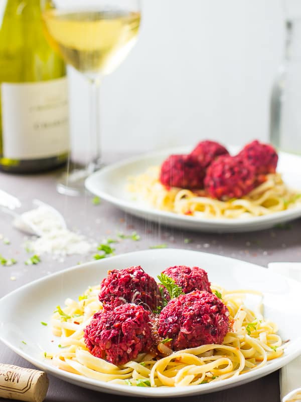 Chickpea and beet balls on a bed of pasta. 