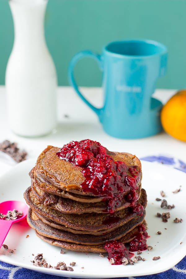 A stack of chocolate peanut butter pancakes on a white plate.