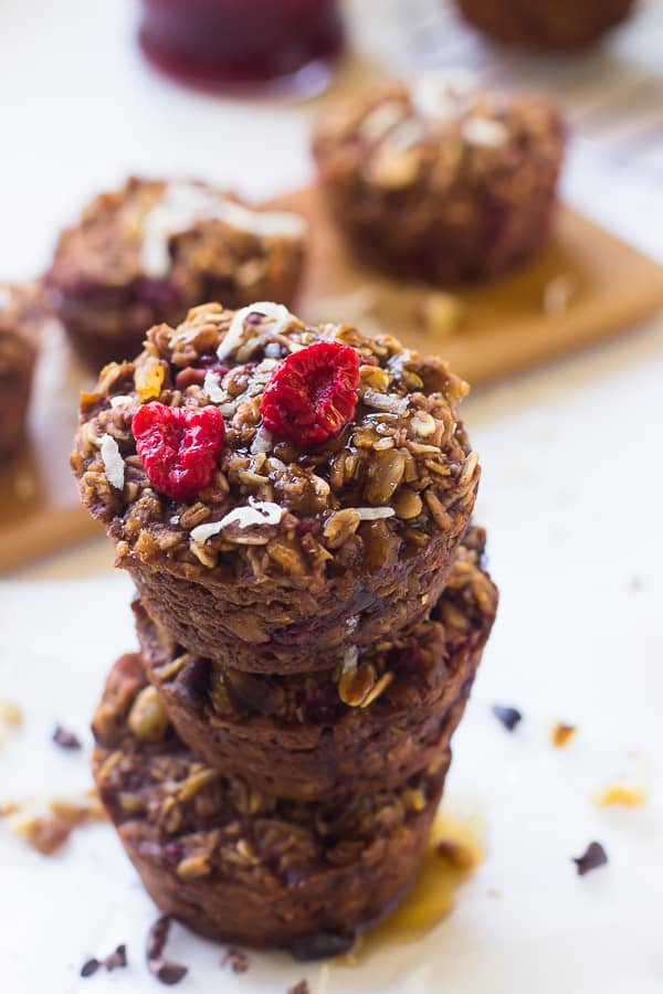 A stack of chocolate raspberry oatmeal cups on a table top.