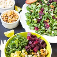 Table with bowl of roast beet salad in a bowl on it.