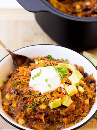 Slow Cooker Sweet Potato, Quinoa and Black Bean Chili in a bowl with a spoon.