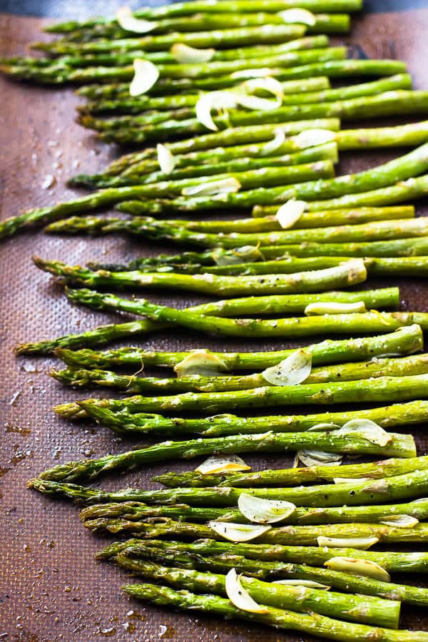 Garlic roasted asparagus on a baking tray.