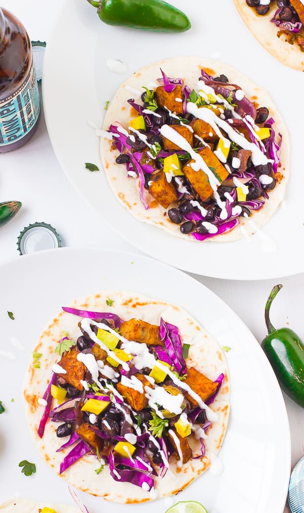 These Sweet Potato and Black Bean Tacos are amazing homemade vegetarian tacos. They are drizzled with a delicious creamy Lime Crema!