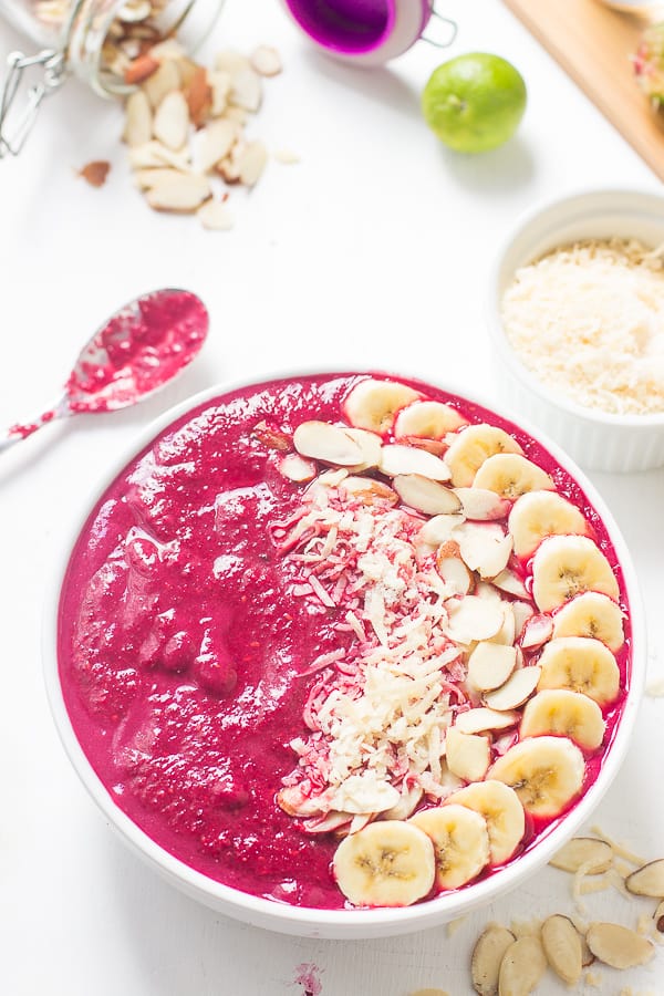 Overhead shot of banana berry beet smoothie bowl with a spoon on the side. 