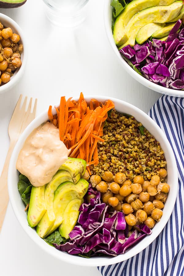 Top down shot of colorful buddha bowl with tahini dressing. 