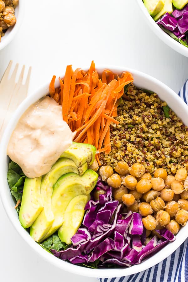 Overhead shot of a colorful buddha bowl on cloth.