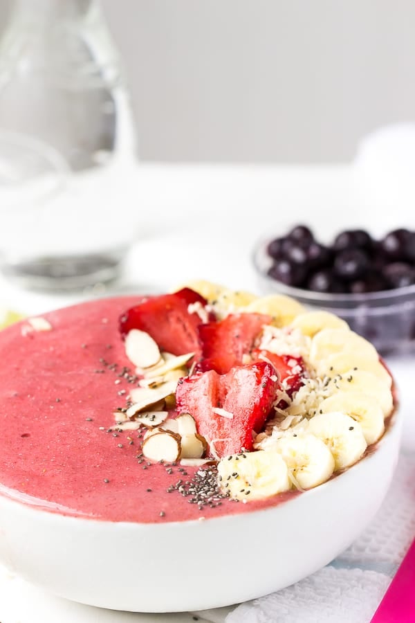 Strawberry lime coconut smoothie bowl with fresh fruit on top. 