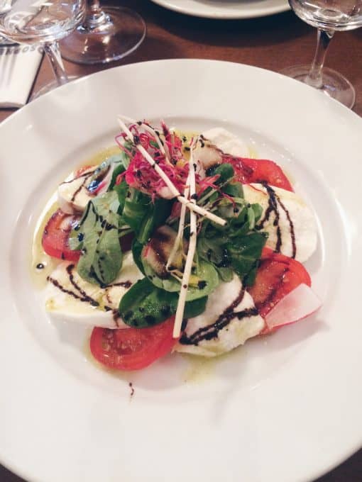 Tomato and mozzarella salad on a white dish. 