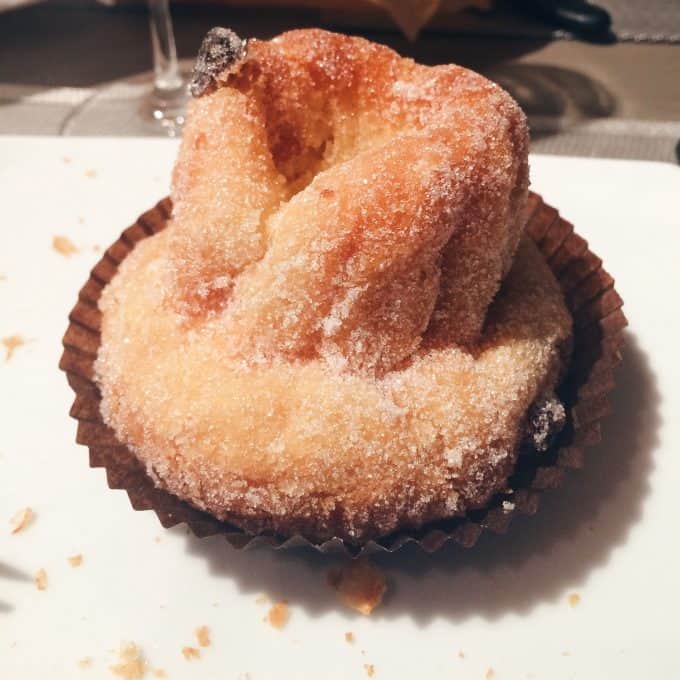 Close up of a pastry in a paper cup. 