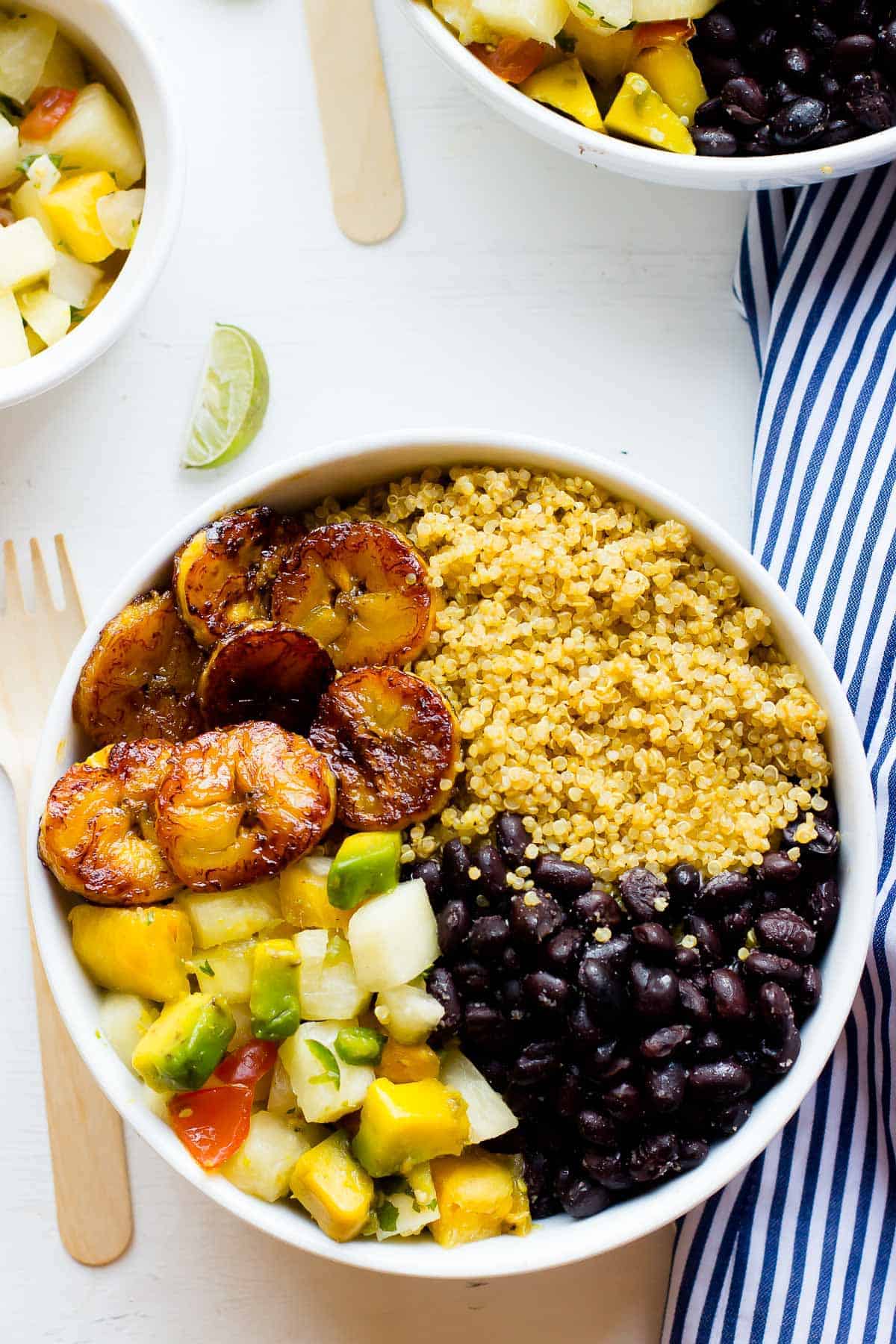 Top down shot of cuban quinoa bowl on a white table. 