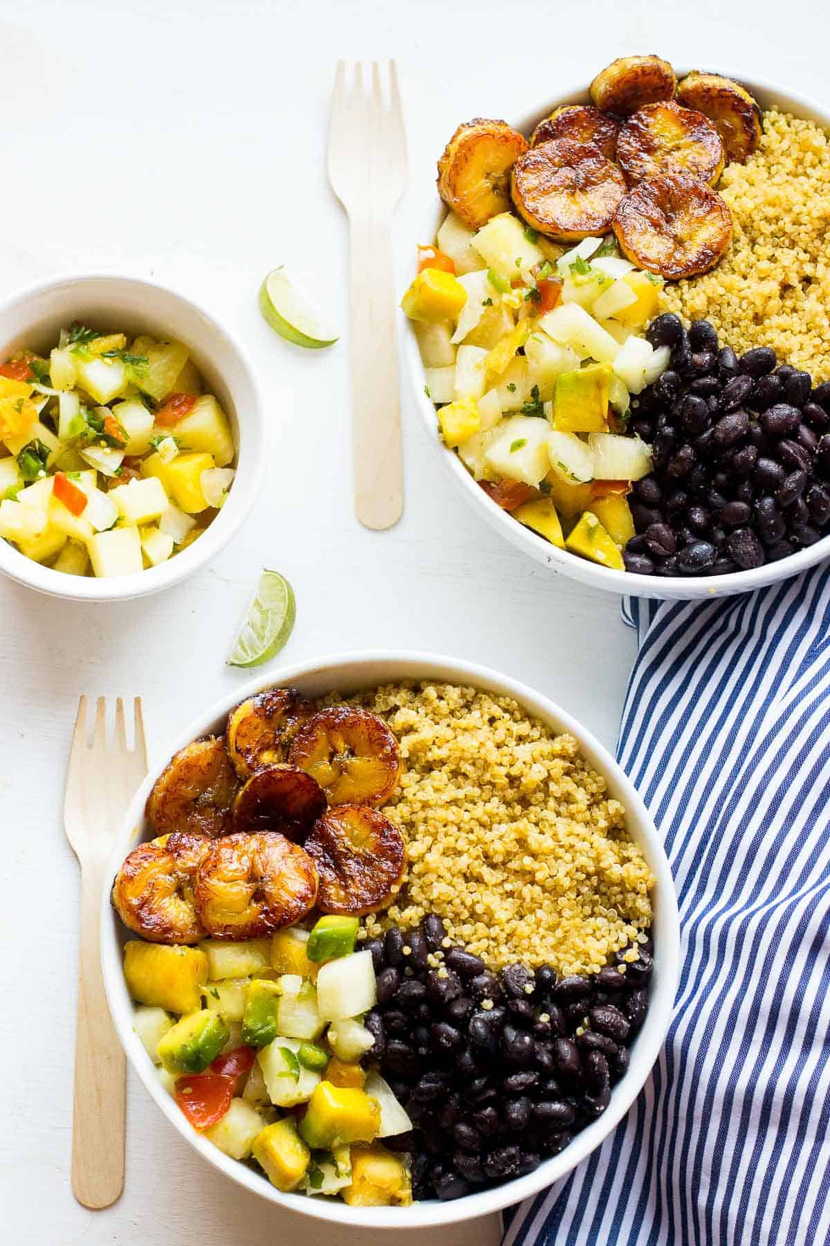Overhead shot of cuban quinoa bowls with forks on the side.