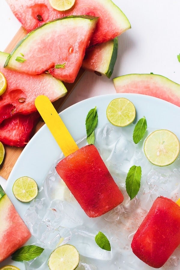 Top down shot of watermelon mint popsicles on ice. 